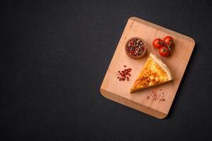 Delicious crispy quiche cut into slices with cheese, broccoli, tomatoes photo