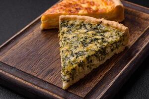 Delicious crispy quiche cut into slices with cheese, broccoli, tomatoes photo