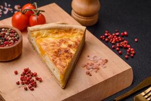 Delicious crispy quiche cut into slices with cheese, broccoli, tomatoes photo