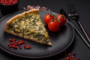 Delicious crispy quiche cut into slices with cheese, broccoli, tomatoes photo