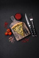 Delicious crispy quiche cut into slices with cheese, broccoli, tomatoes photo