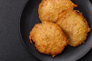 Delicious crispy pancakes made from potatoes, meat, carrots, onions photo