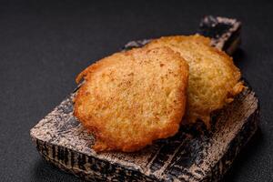 Delicious crispy pancakes made from potatoes, meat, carrots, onions photo