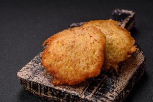 Delicious crispy pancakes made from potatoes, meat, carrots, onions photo