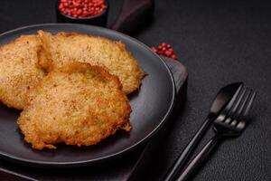 Delicious crispy pancakes made from potatoes, meat, carrots, onions photo