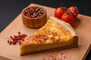 Delicious crispy quiche cut into slices with cheese, broccoli, tomatoes photo