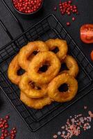 Delicious nutritious squid or onion rings deep fried with salt and spices photo