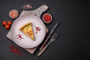 Delicious crispy quiche cut into slices with cheese, broccoli, tomatoes photo