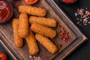 Delicious crispy cheese sticks with mozzarella, salt and spices photo