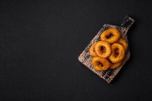 Delicious nutritious squid or onion rings deep fried with salt and spices photo