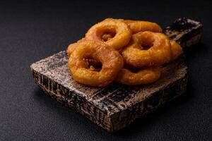 Delicious nutritious squid or onion rings deep fried with salt and spices photo