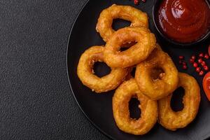 Delicious nutritious squid or onion rings deep fried with salt and spices photo