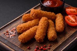 Delicious crispy cheese sticks with mozzarella, salt and spices photo