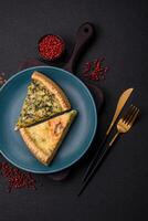 Delicious crispy quiche cut into slices with cheese, broccoli, tomatoes photo