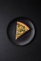 Delicious crispy quiche cut into slices with cheese, broccoli, tomatoes photo