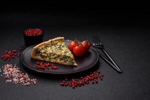 Delicious crispy quiche cut into slices with cheese, broccoli, tomatoes photo