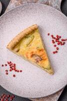 Delicious crispy quiche cut into slices with cheese, broccoli, tomatoes photo
