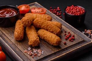 Delicious crispy cheese sticks with mozzarella, salt and spices photo