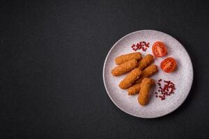 Delicious crispy cheese sticks with mozzarella, salt and spices photo