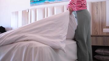 Woman changing bed linens at home, making bed video