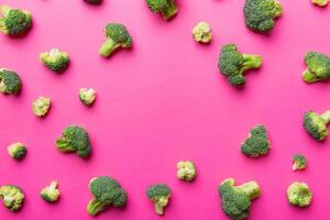 Flat lay composition with fresh green broccoli frame eith copy space on light background photo