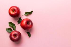 Many red apples on colored background, top view. Autumn pattern with fresh apple above view with copy space for design or text photo