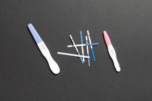 Colored Pregnancy test on colored background, top view with copy space photo