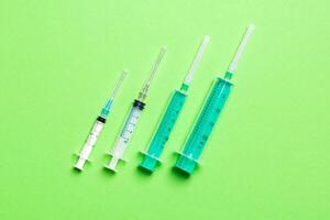 Top view of medical syringes on colorful background. Health care concept with copy space photo