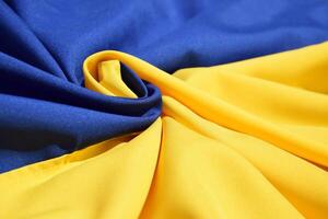 Fabric bent national flag of Ukraine, UA. photo