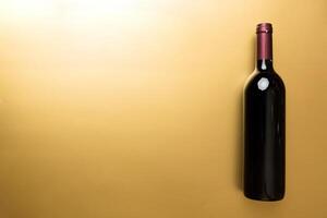 One Bottle of red wine on colored table. Flat lay, top view wth copy space photo