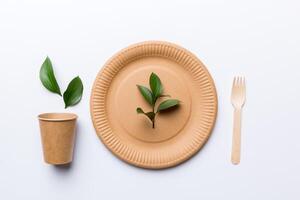 set of empty reusable disposable eco-friendly plates, cups, utensils on light white colored table background. top view. Biodegradable craft dishes. Recycling concept. Close-up photo