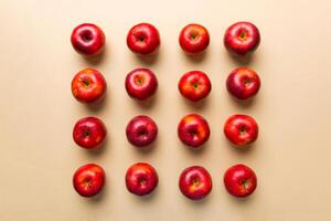 Many red apples on colored background, top view. Autumn pattern with fresh apple above view photo