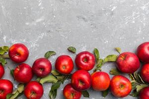 muchos rojo manzanas en de colores fondo, parte superior vista. otoño modelo con Fresco manzana encima ver con Copiar espacio para diseño o texto foto