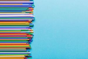 Heap of colorful plastic drinking straws on Colored background, flat lay. Copy Space for text photo