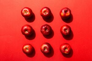Many red apples on colored background, top view. Autumn pattern with fresh apple above view photo