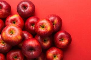 Many red apples on colored background, top view. Autumn pattern with fresh apple above view with copy space for design or text photo