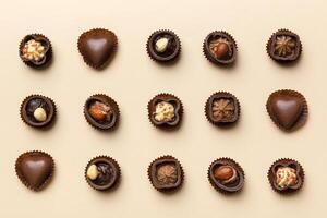 Different kinds of chocolates on colored table close-up. Top View and Flat Lay photo