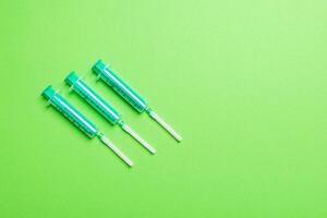 Top view of syringes in a row for medical injection on colorful background with copy space. Health and vaccination concept photo