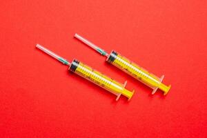 Top view of medical syringes on colorful background with copy space. Injection equipment concept photo