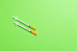 Top view of insulin syringes ready for injection on colorful background. Diabetic concept with copy space photo