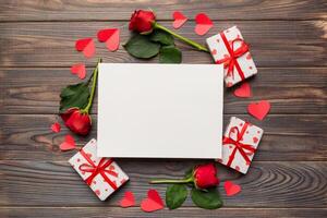 Frame made of rose, git box, heart and blank greeting card mockup on Colored background. Top view, flat lay, copy space Holiday, Mothers Day, birthday concept photo