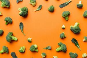 Flat lay composition with fresh green broccoli frame eith copy space on light background photo