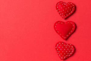 Top view of textile hearts on colorful background. Valentine's day concept with copy space photo