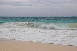 Waves breaking on the beach photo