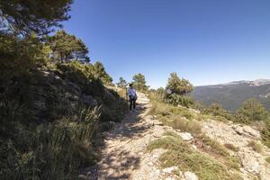 Caucasian mature woman hiking through the beautiful nature of the Sierra de Cazorla, Jaen, Spain. photo