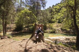 Caucasian mature woman hiking through the beautiful nature of the Sierra de Cazorla, Jaen, Spain. photo