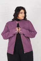 un mujer en un púrpura chaqueta y negro pantalones foto