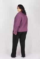 a woman in a purple jacket and black pants photo