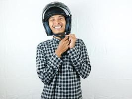 Portrait Asian man holding motorcycle helmet with excited expression. Safety riding. photo