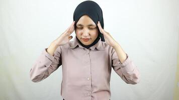 Portrait Asian Muslim woman doing stress and headache expression. photo